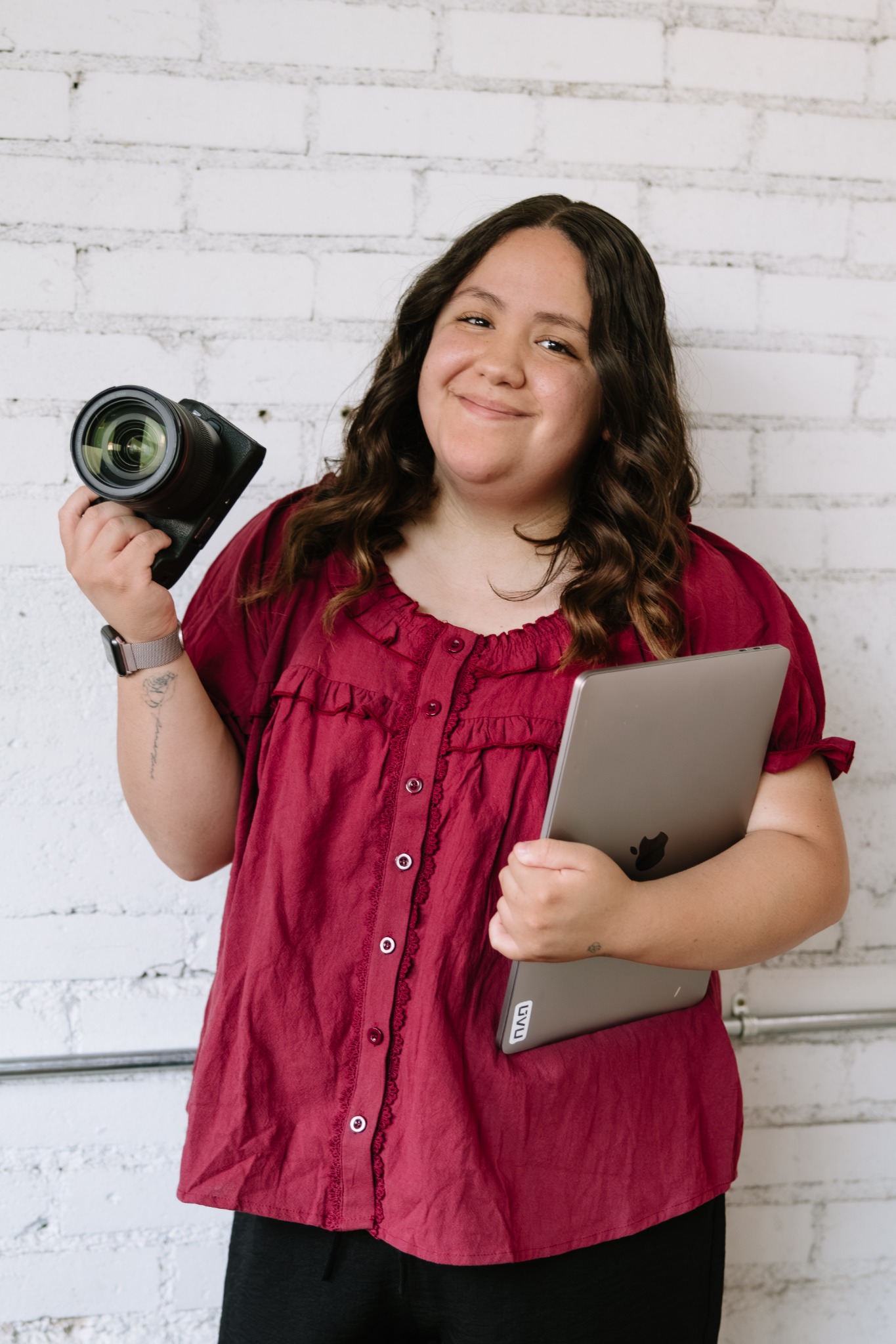 Sammy Becerra holding a camera and tablet